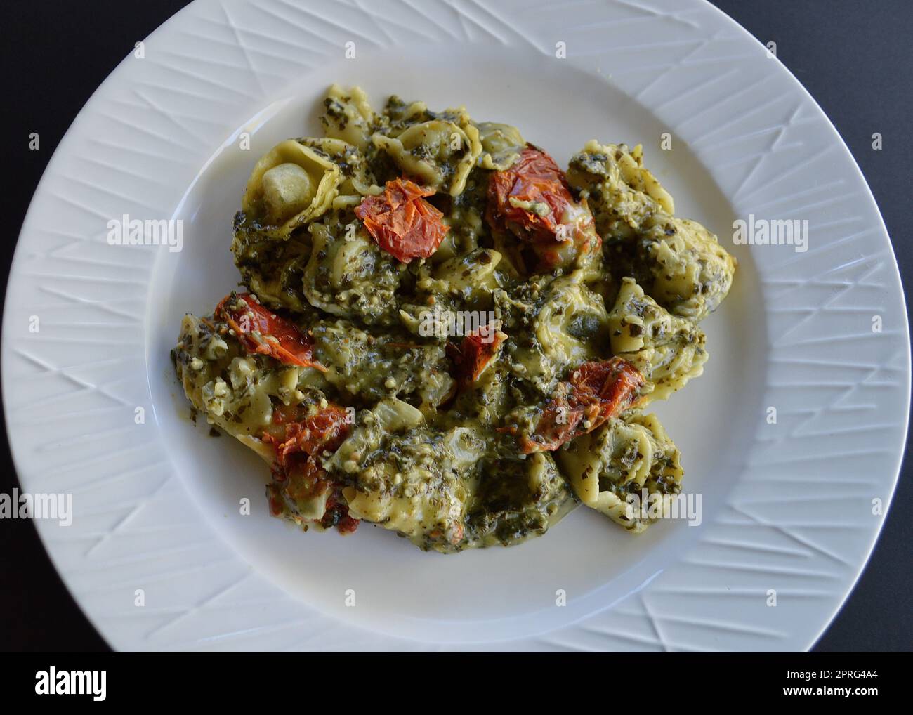 Spinach and ricotta tortellini with pesto sauce Stock Photo