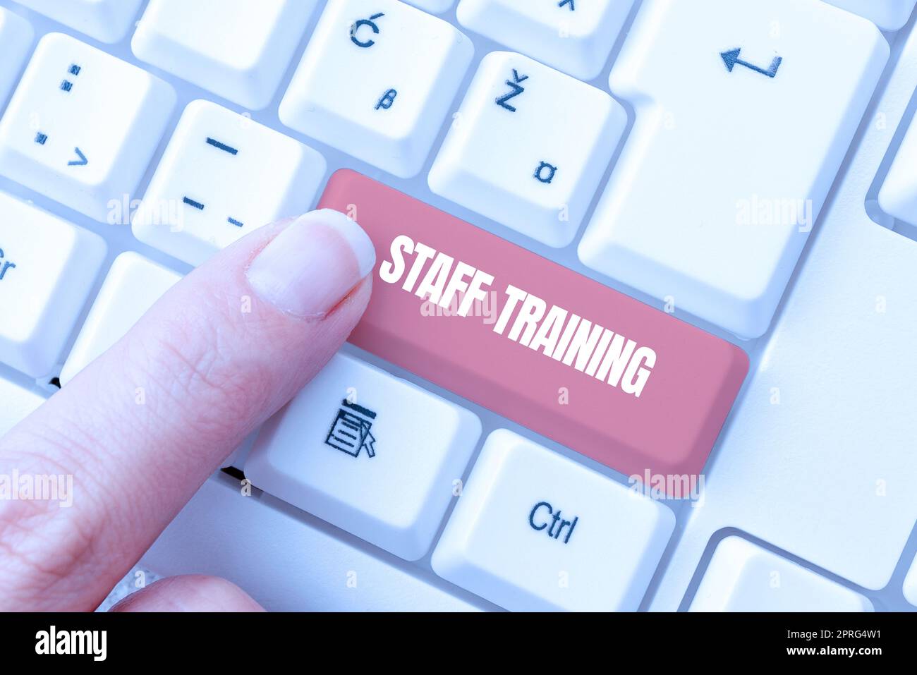 Sign displaying Staff TrainingA program that helps employees to learn specific knowledge. Internet Concept A program that helps employees to learn specific knowledge Businessman in suit holding tablet symbolizing successful teamwork. Stock Photo