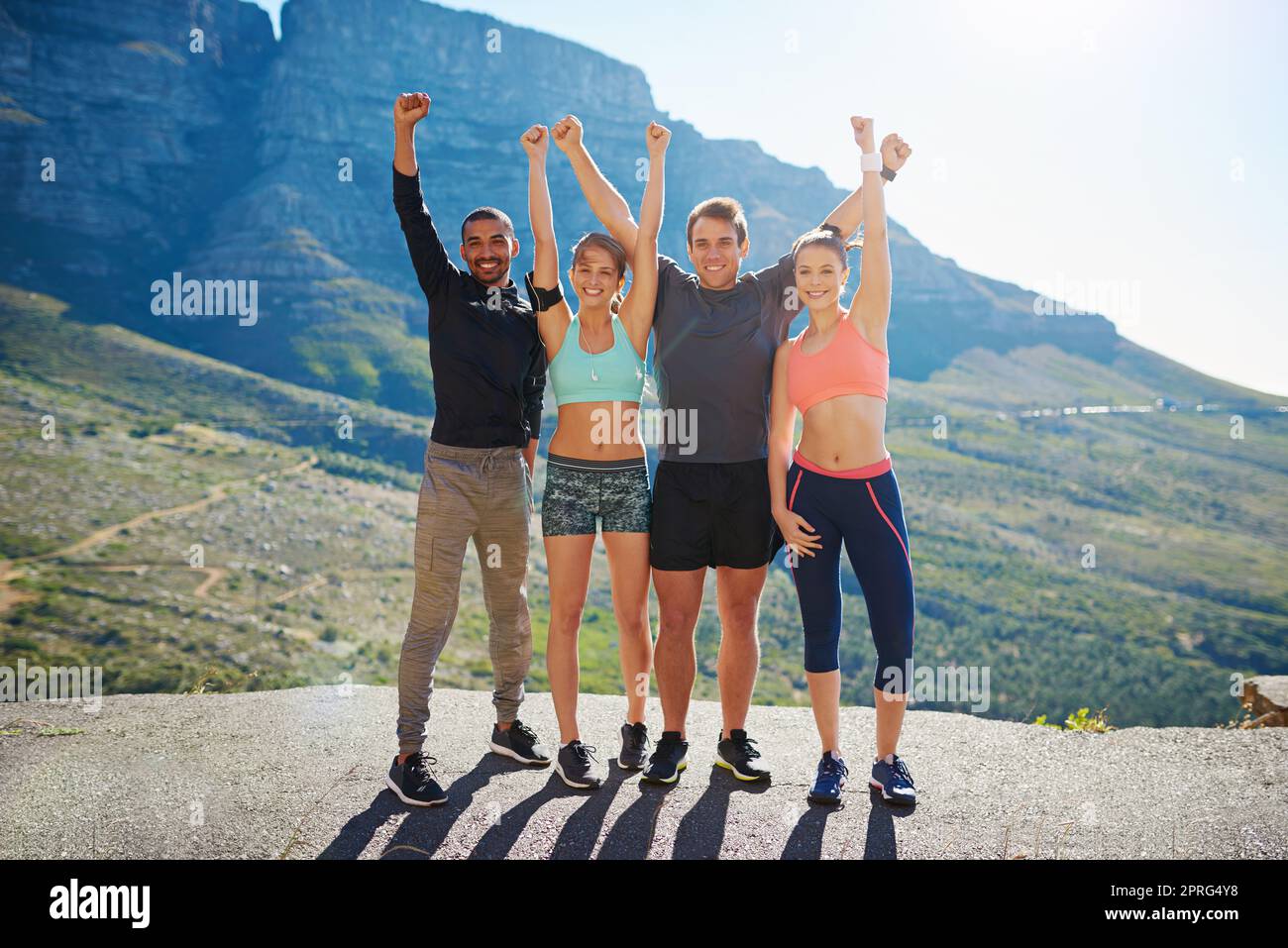 It pays to have a healthier outlook on life. Portrait of a fitness group celebrating after a workout outside. Stock Photo