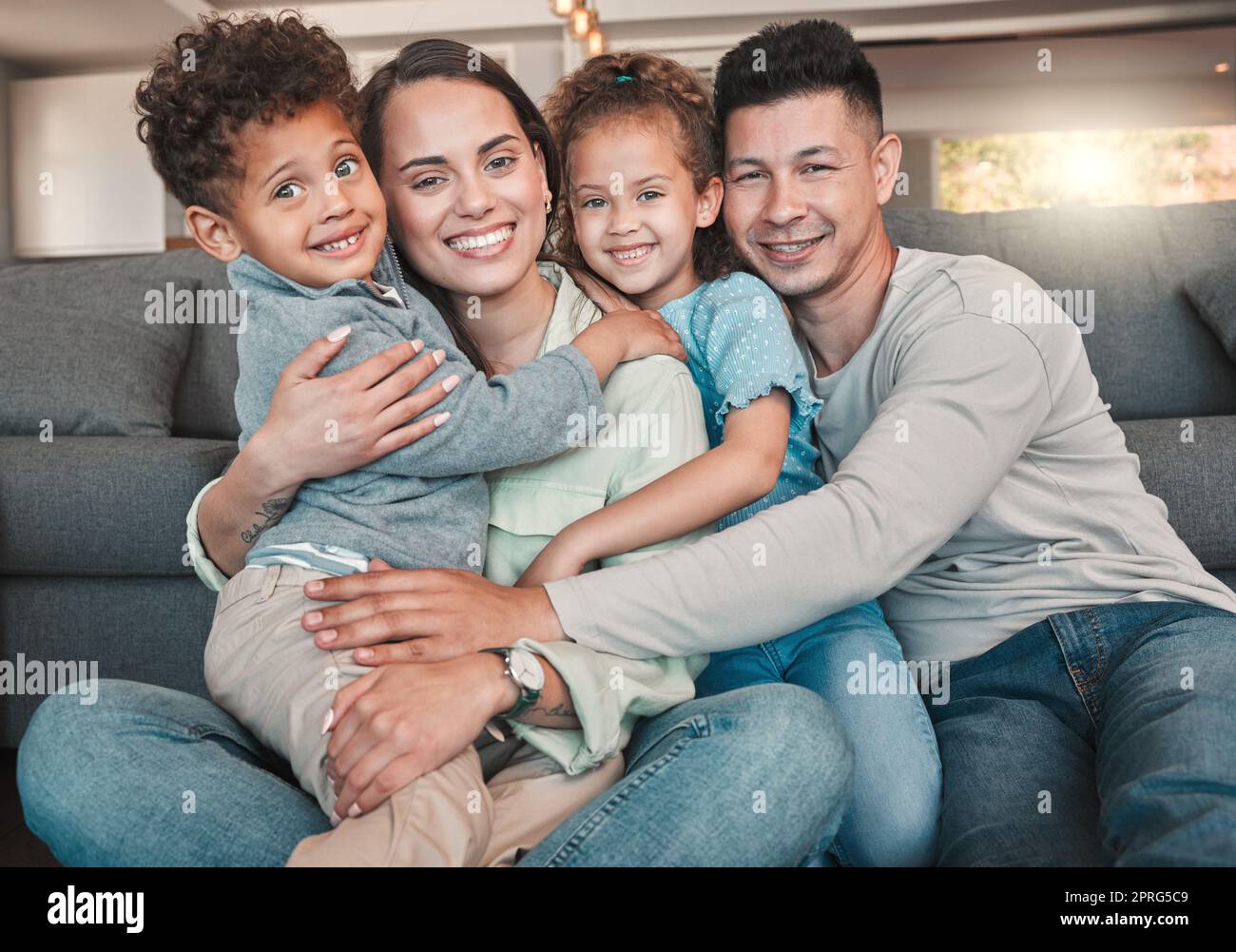 They make life fun. a young family spending time together at home. Stock Photo