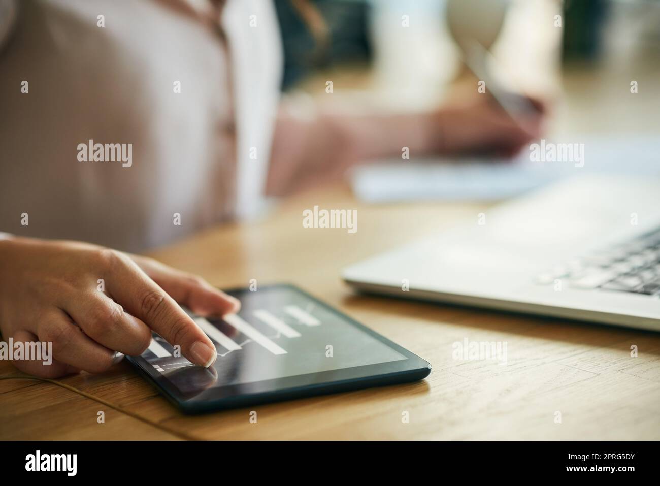 Hand, graph and technology while a woman zoom in on a tablet to check the growth and development of her company. Closeup of a businesswoman, data analyst and accountant checking financial charts Stock Photo