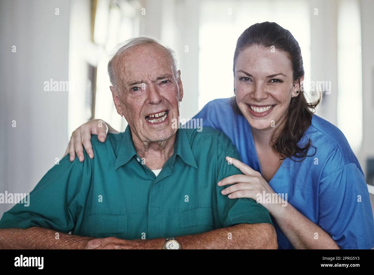 I make sure that hes taken care of. a female nurse standing next to her senior patient. Stock Photo