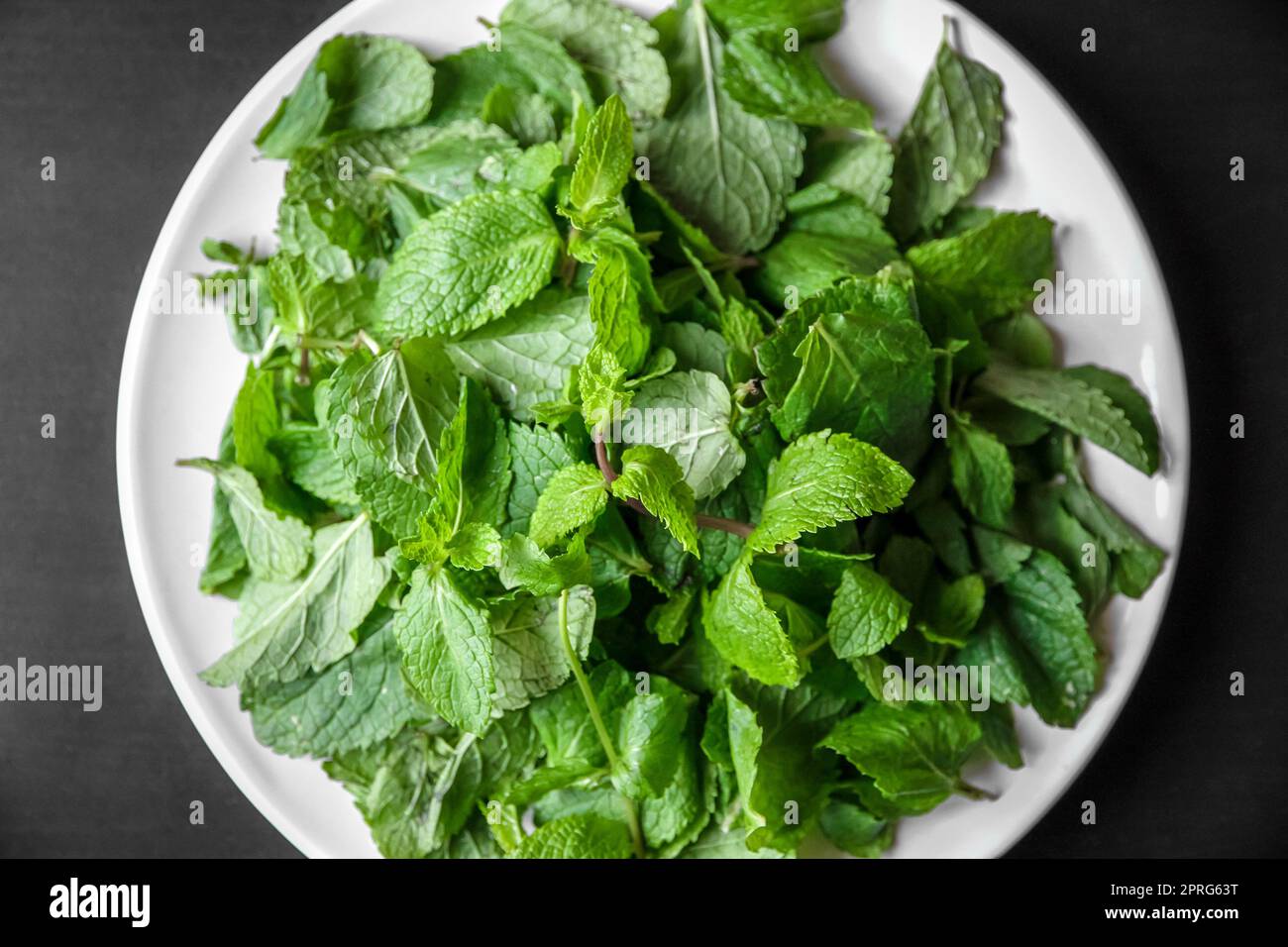 Fresh mint leaves on a plate Stock Photo