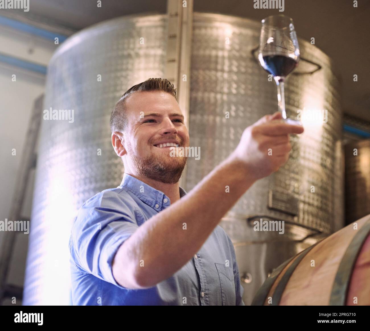 Making great wines using traditional, natural viticultural and winemaking methods. a man enjoying wine tasting in his distillery. Stock Photo