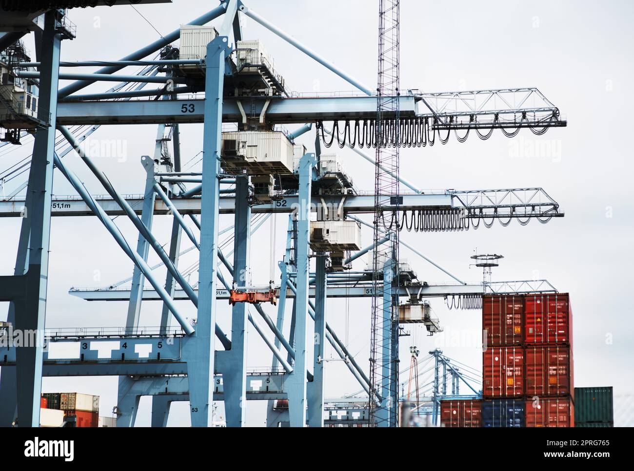 Cargo container crane, shipping logistics machine and industrial stock for global supply chain, factory manufacturing and export trade. Wholesale production, freight industry and commercial storage Stock Photo