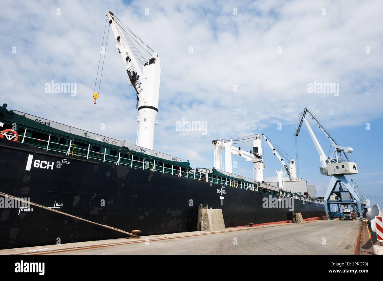Shipping, logistics and supply chain with a ship in a harbor for freight and cargo delivery. Shipment, courier and service with a commercial and industrial vessel in the export and transport industry Stock Photo