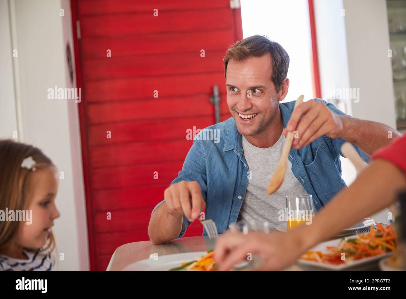 Good food, good mood. a happy family enjoying a home-cooked meal together at the table. Stock Photo