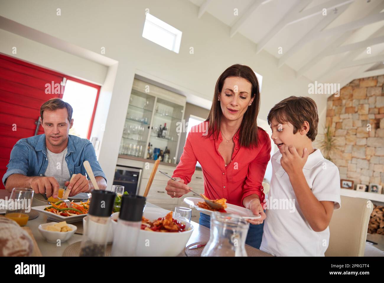 There is no love sincerer than the love of food. a happy family enjoying a home-cooked meal together at the table. Stock Photo