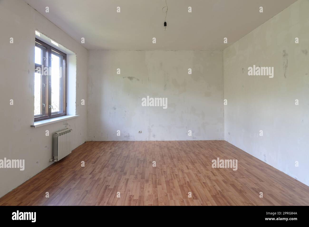 Interior of a small empty room with one window during renovation Stock