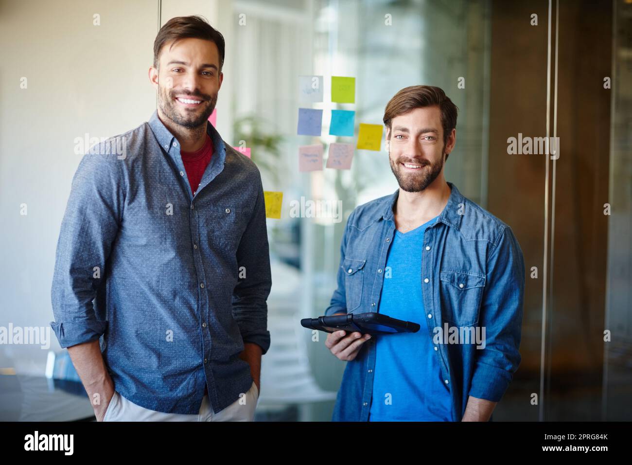 Were the face of success. Portrait of two young businessmen standing together in an office. Stock Photo