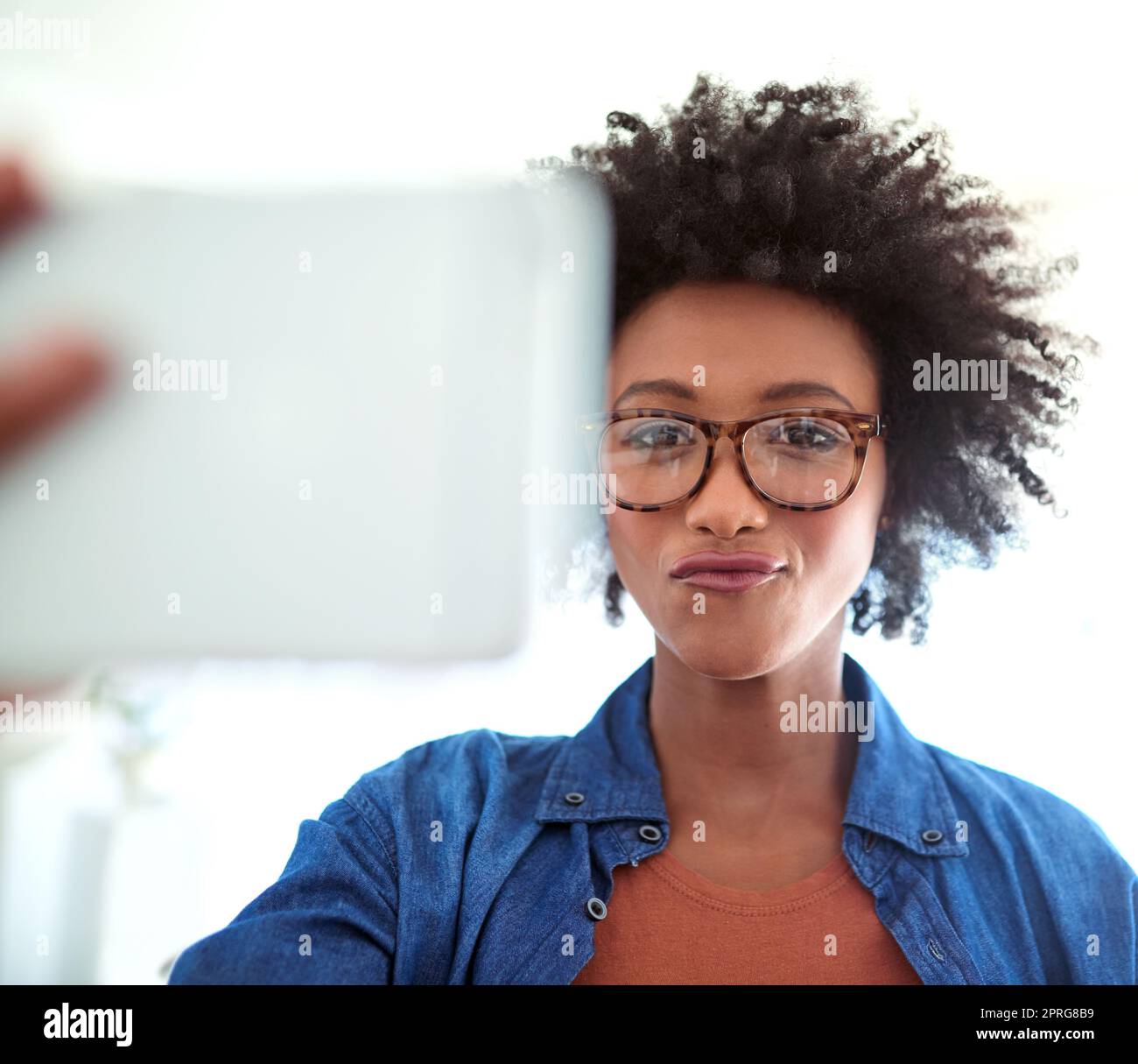 Time for a selfie. Portrait of an attractive young woman taking a selfie at home. Stock Photo