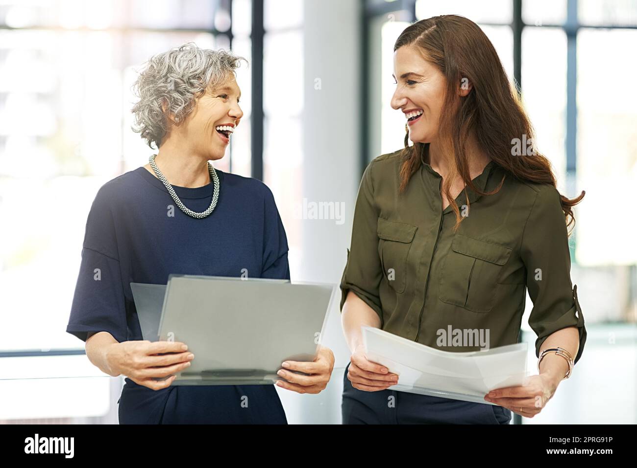 Achieving excellence together. two colleagues working together in an office. Stock Photo