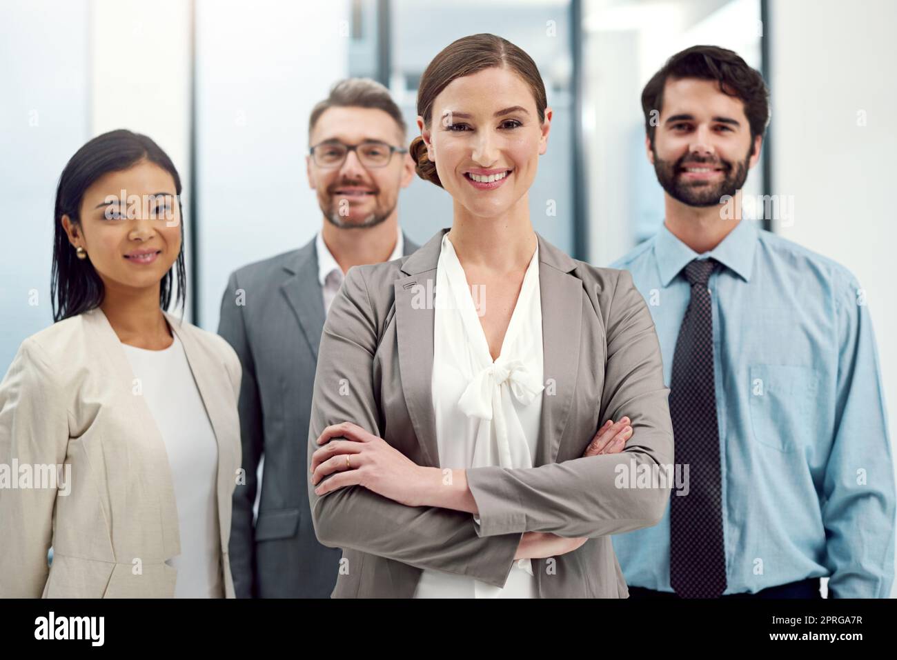Trust the experts. Portrait of a group of businesspeople standing together in a modern office. Stock Photo