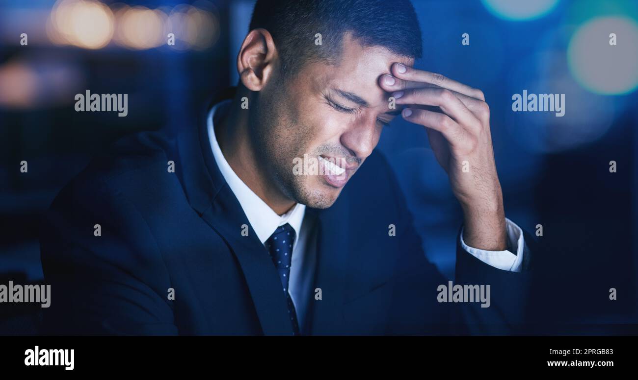 Headache, stress and burnout with businessman working late night in corporate office building. Anxiety, mental health and migraine pain with audit, tax or risk company employee sitting at desktop Stock Photo