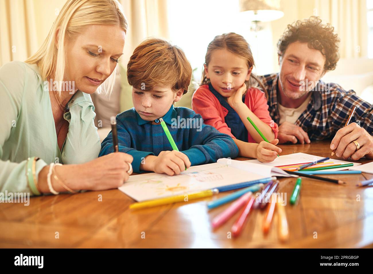 Sparking creativity. a family drawing and colouring in pictures together at home. Stock Photo