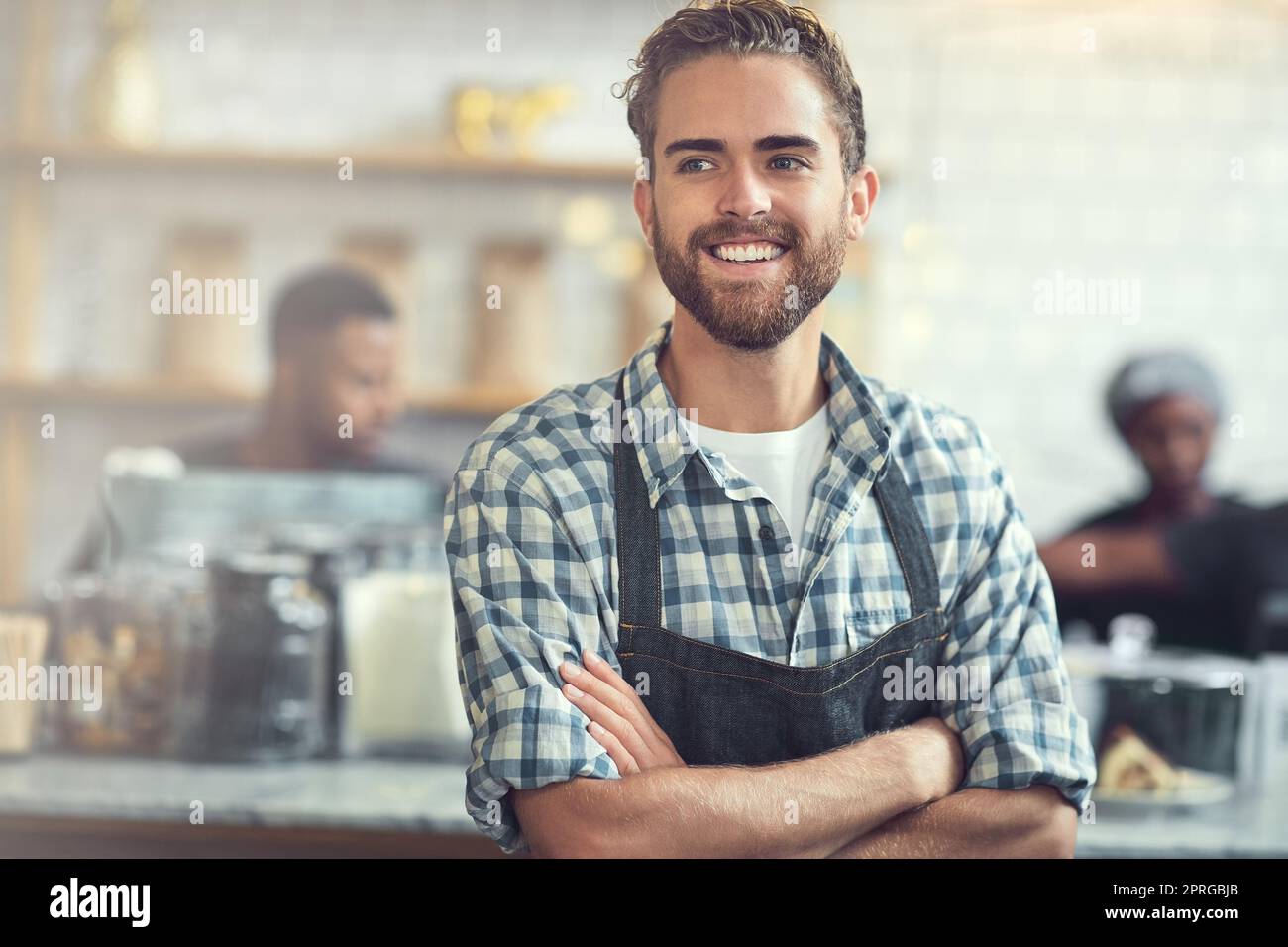 Hes got a strong work ethic. a confident young man working in his store. Stock Photo
