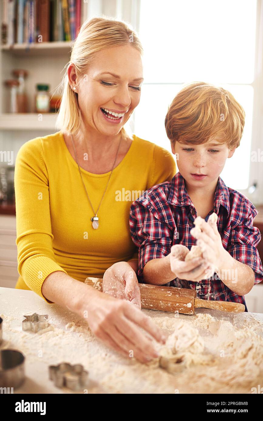 Baking using Moms secret recipe. a mother and son baking together at home. Stock Photo
