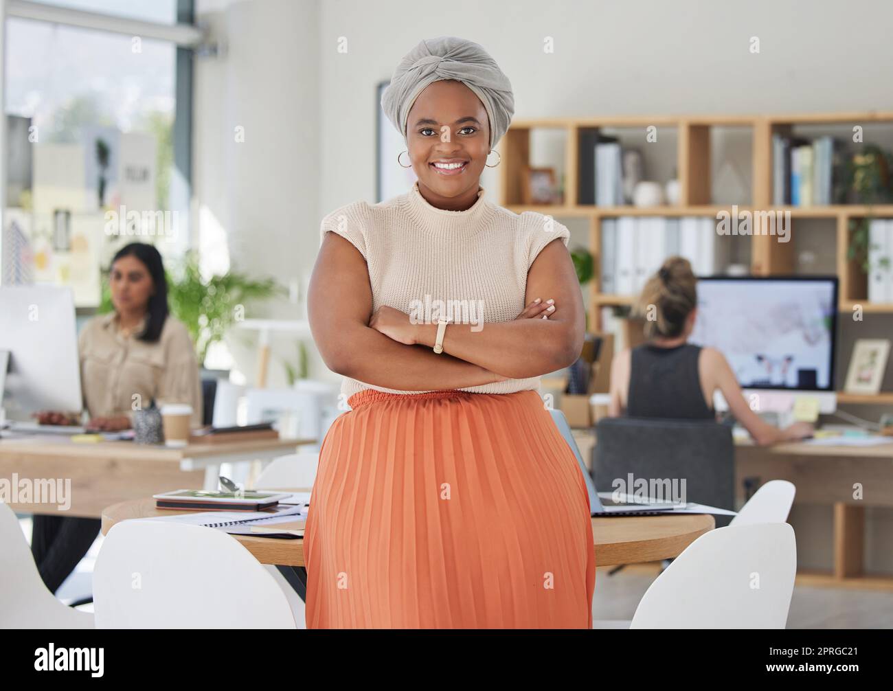 Innovation, leadership and a proud black business woman standing in power in a corporate office. Happy African American leader excited by successful goal management with diverse female employees Stock Photo