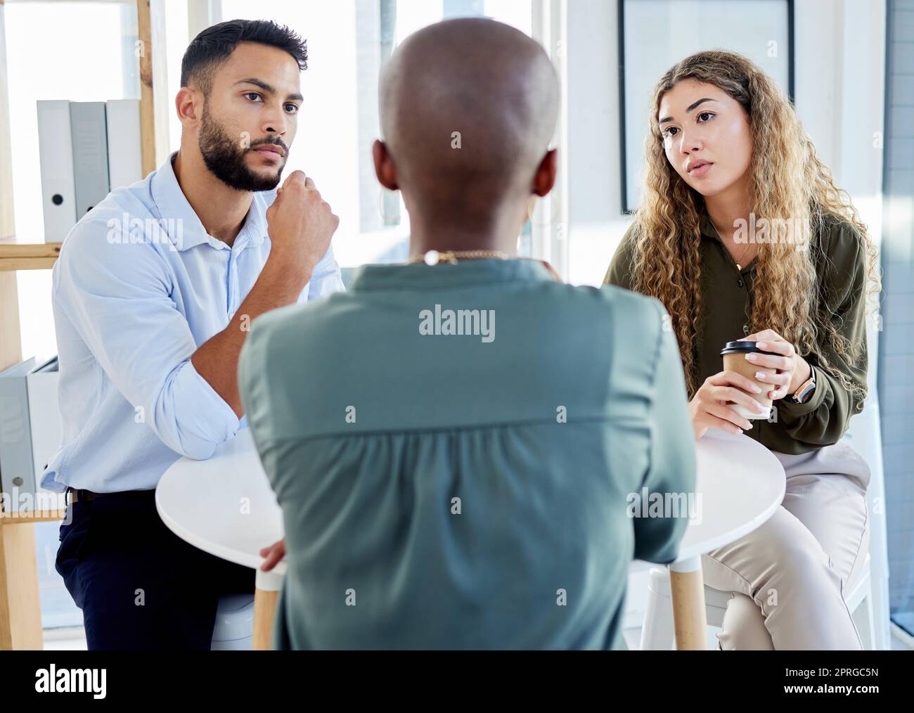 Business meeting, serious discussion or b2b negotiation with HR, leader or manager at a table . Communication, advisor or mentor talking, explaining and planning with team for problem solving idea Stock Photo