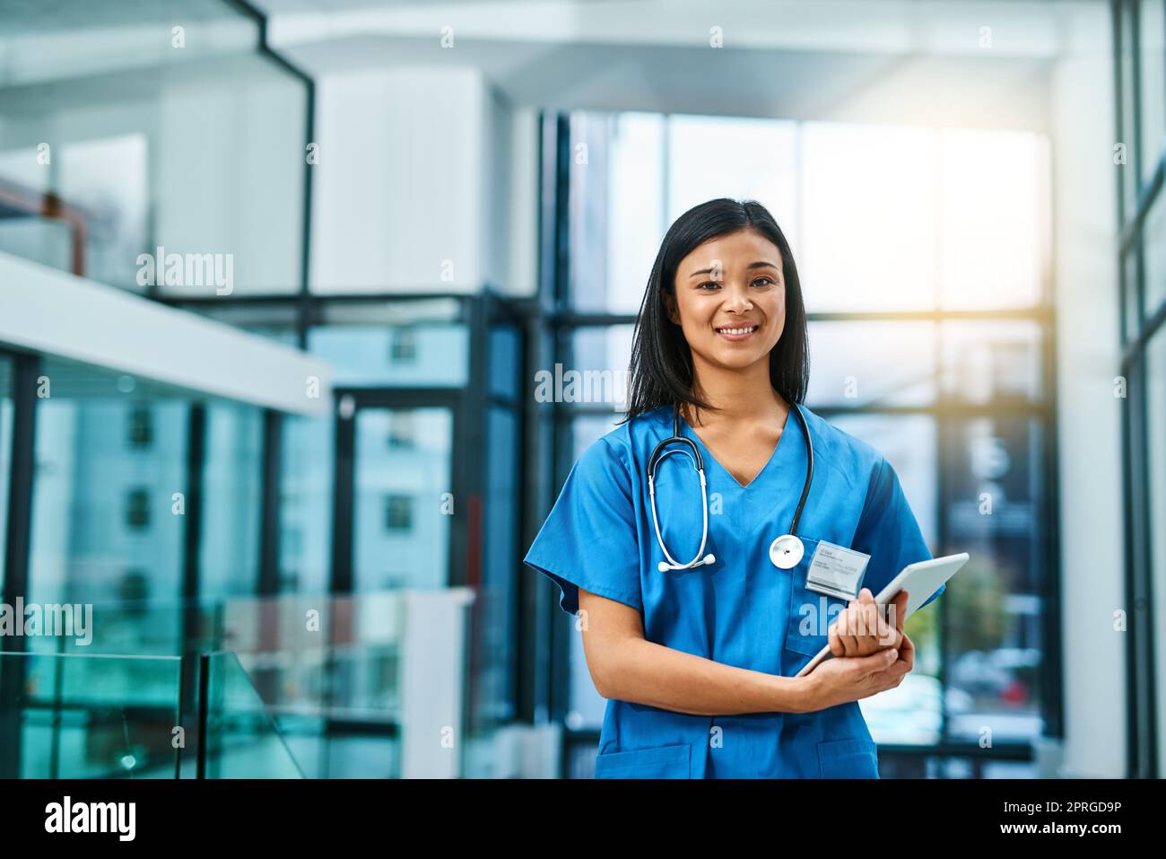Here to offer guidance to all your health concerns. Portrait of a young nurse standing in a hospital. Stock Photo