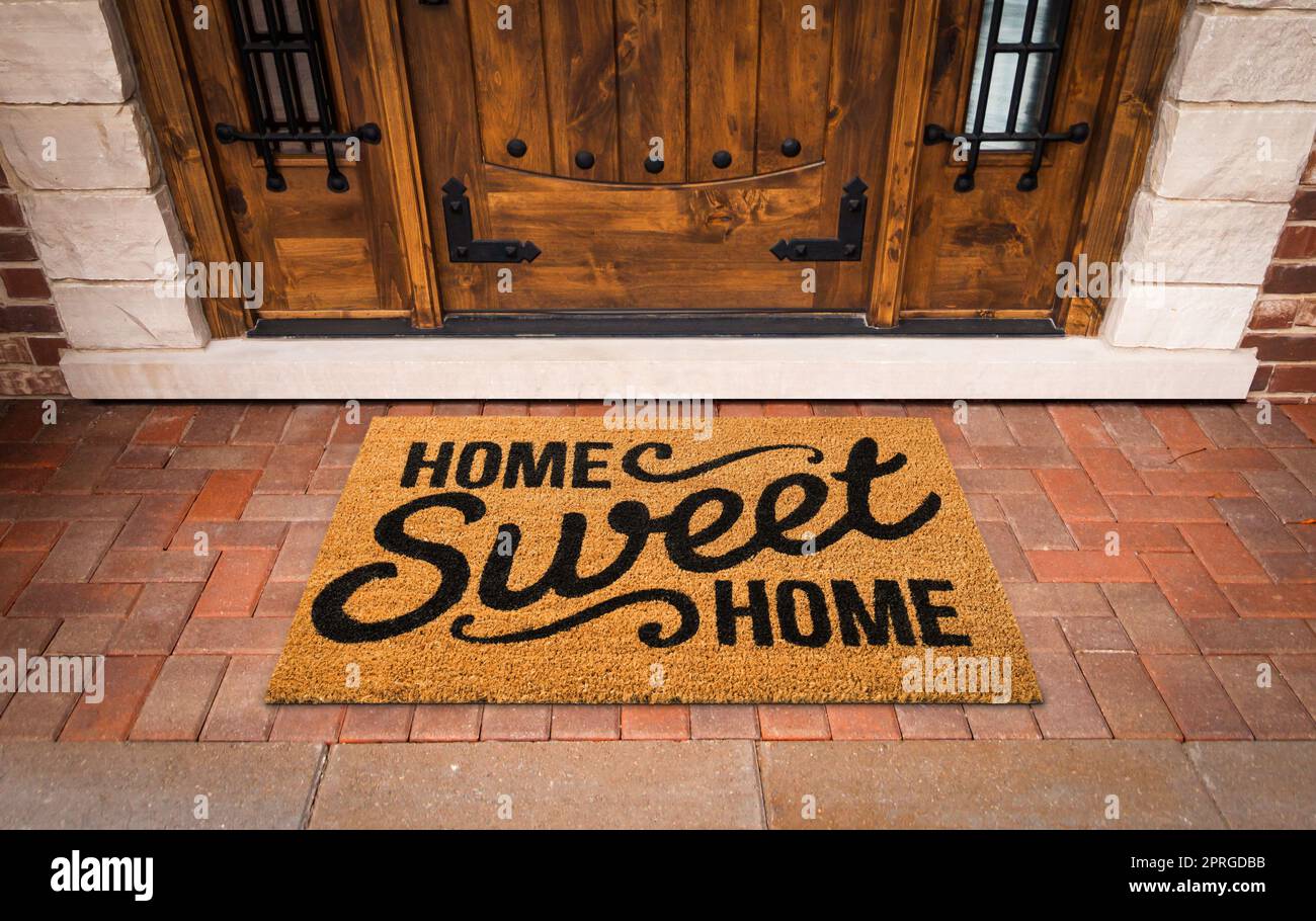 Home Sweet Home Mat At Custom Front Door of House Stock Photo
