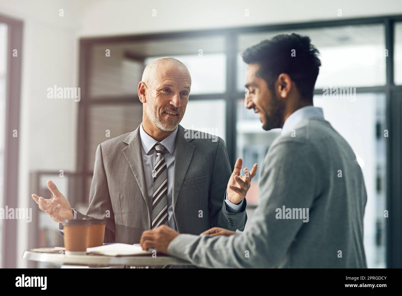 Its the perfect strategy. two businessmen talking in their office. Stock Photo