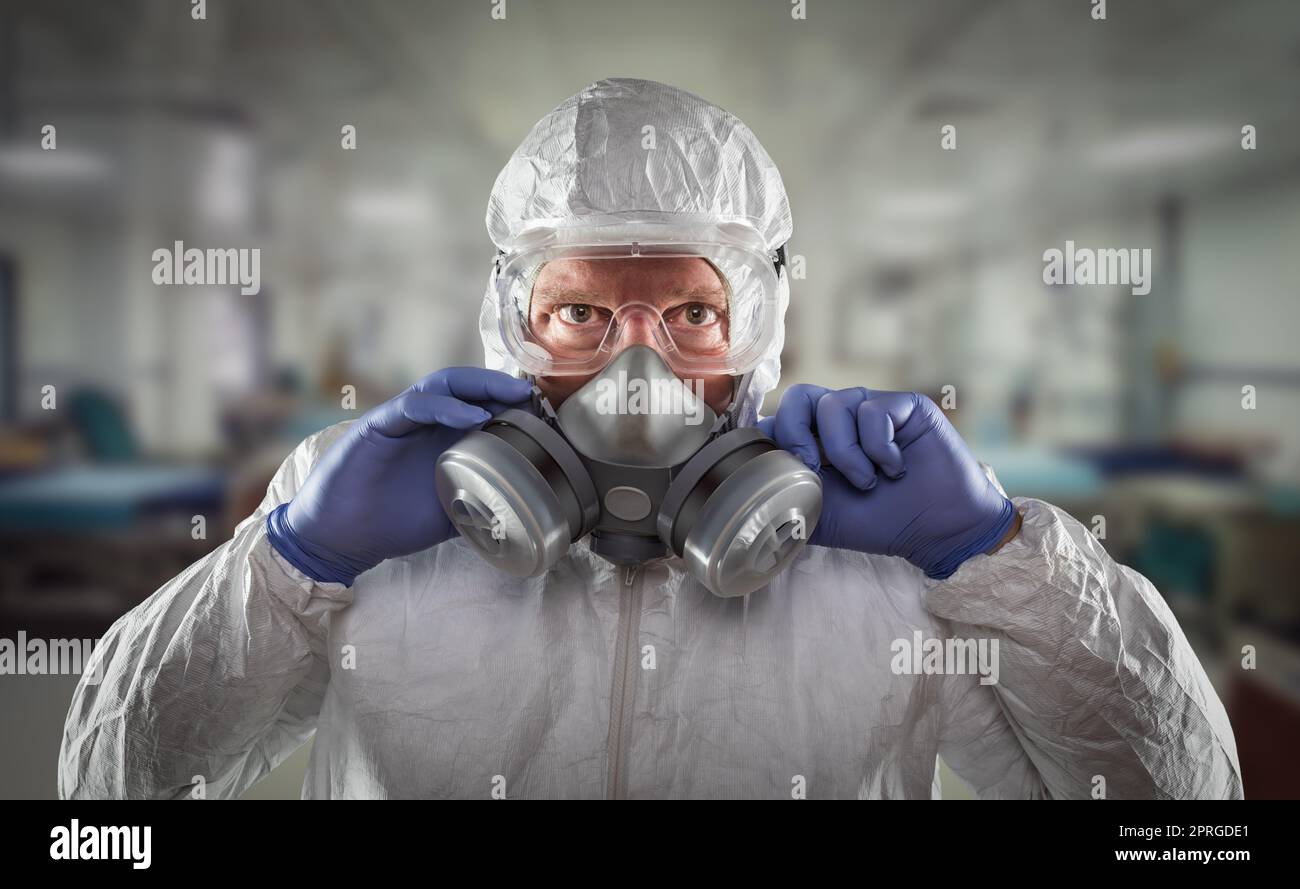 Man Wearing Hazmat Suit, Protective Gas Mask and Goggles Reaching To