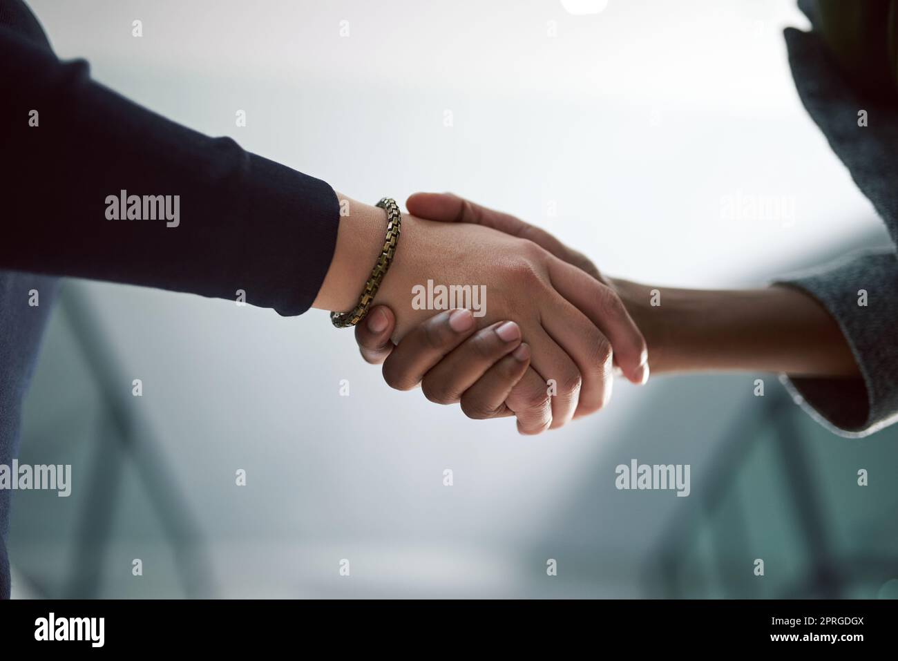 Lets collaborate. two creative businesspeople shaking hands. Stock Photo