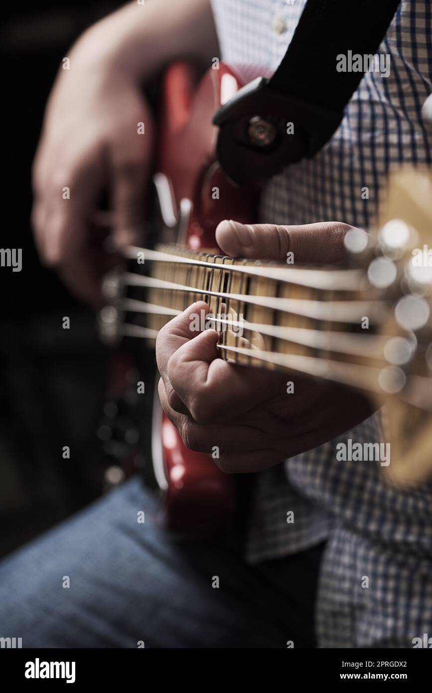 Saturday jam session. an unrecognizable man playing an electric guitar at home. Stock Photo
