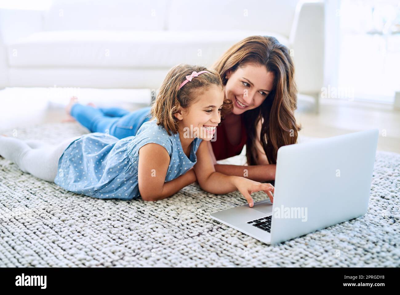 Let me show you this funny video. a mother and daughter using a laptop together at home Stock Photo Alamy