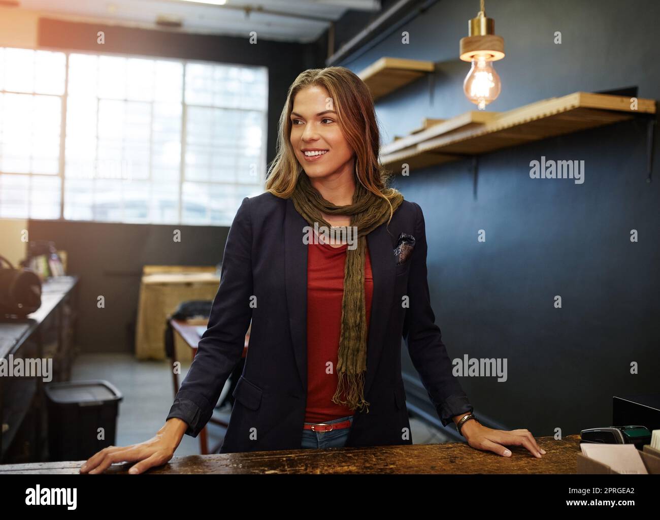 Hard work is my secret to succeeding. a young business owner standing in her shop. Stock Photo