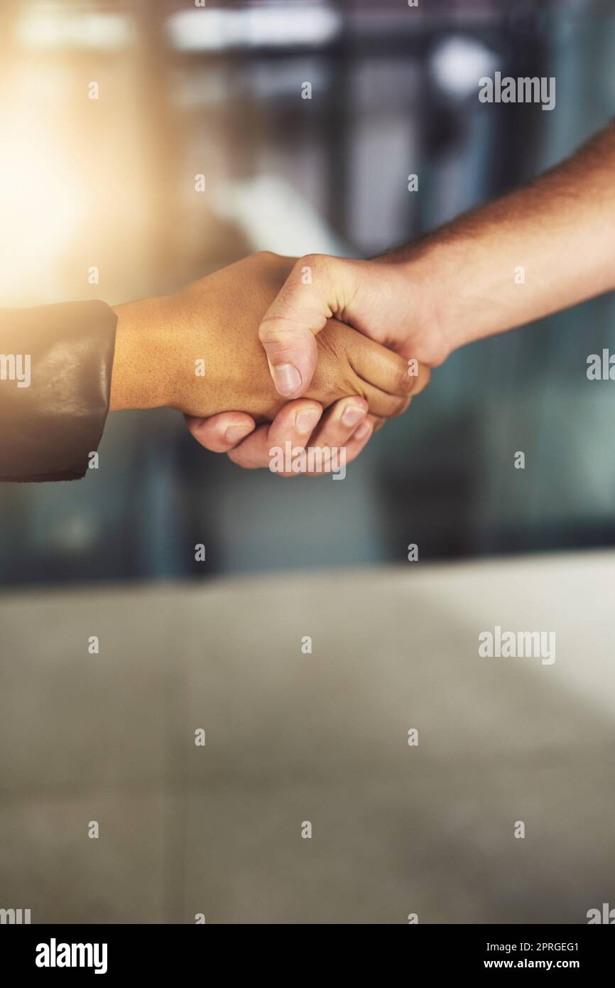 Do business with people you can trust. two businesspeople shaking hands. Stock Photo