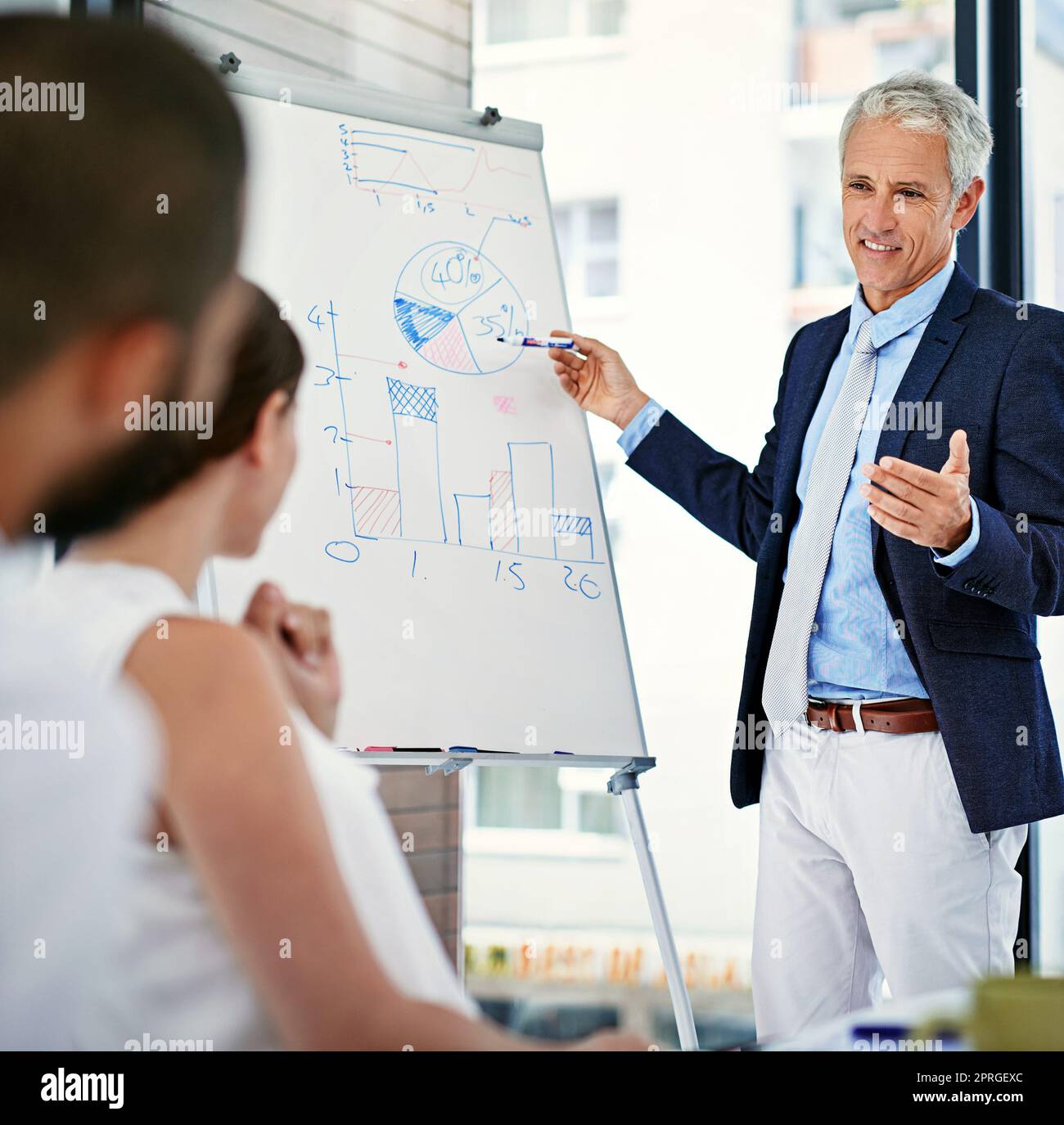 Lets incorporate your great ideas into the project. a businessman giving a presentation to colleagues in an office. Stock Photo