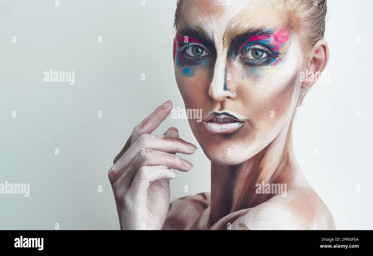 Colour me beautiful. Studio portrait of a young woman posing with paint on her face. Stock Photo