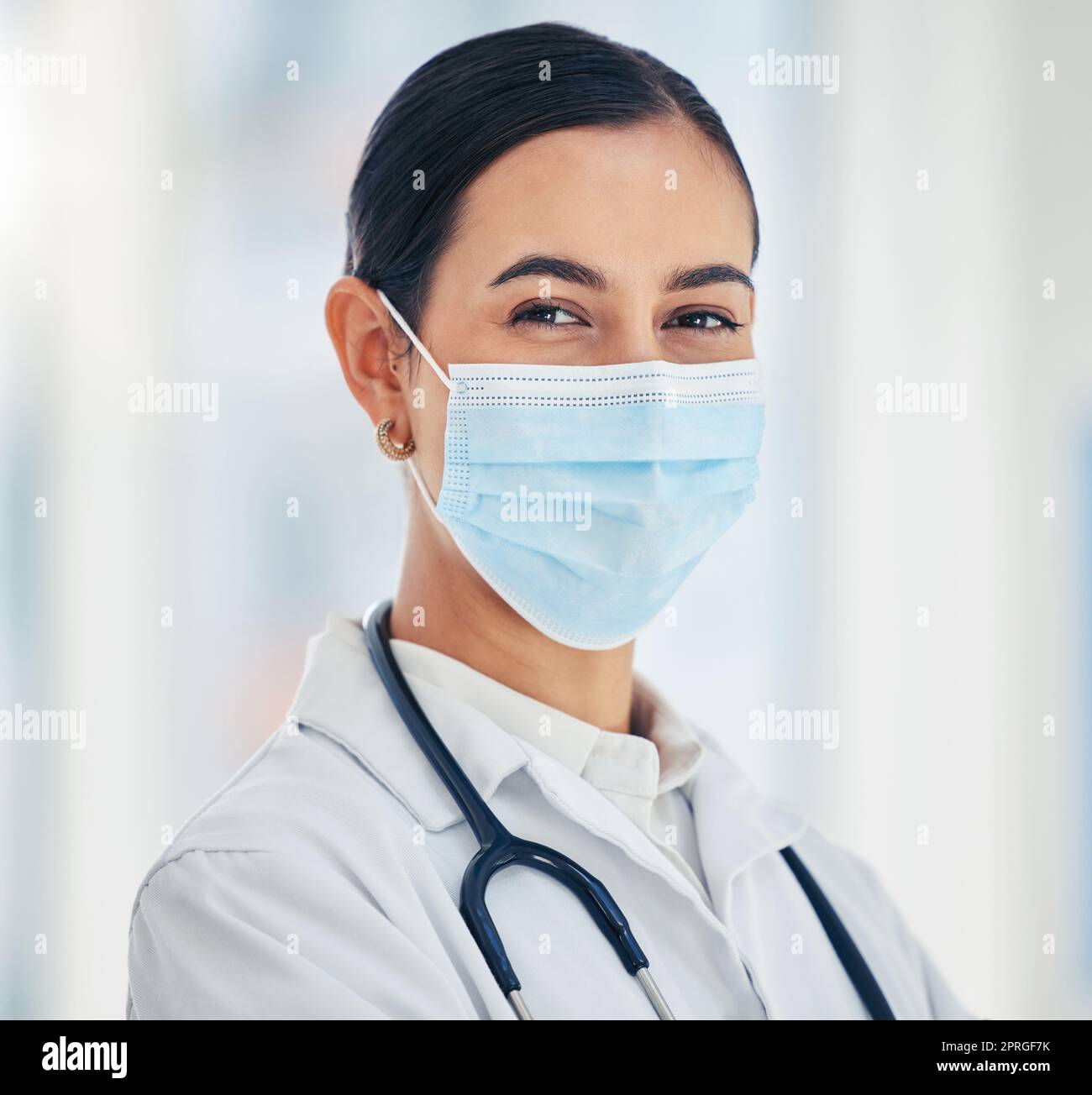 Covid doctor with face mask for safety, medicine and hygiene while working in a medical hospital or clinic. Portrait of woman nurse, healthcare expert and professional worker in corona virus pandemic Stock Photo