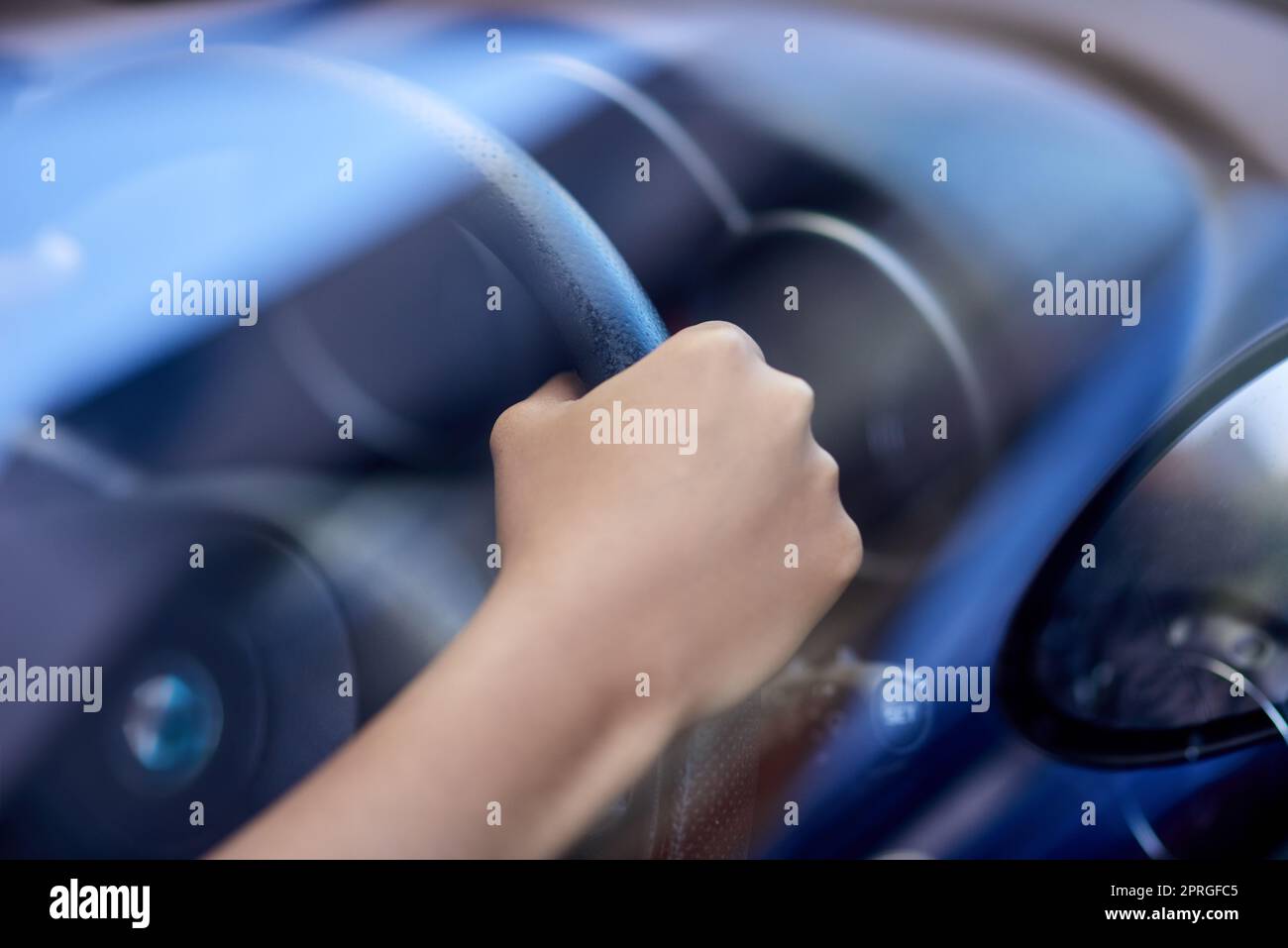 Hold on tight. hands holding onto a steering wheel while driving. Stock Photo
