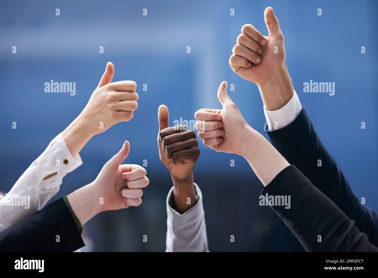 Youve done a great job. a group of office workers giving thumbs up together. Stock Photo