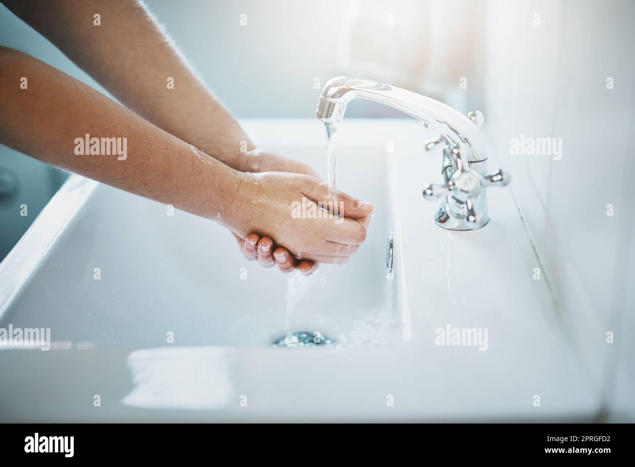 Healthy hand washing habits. hands being washed at a tap. Stock Photo