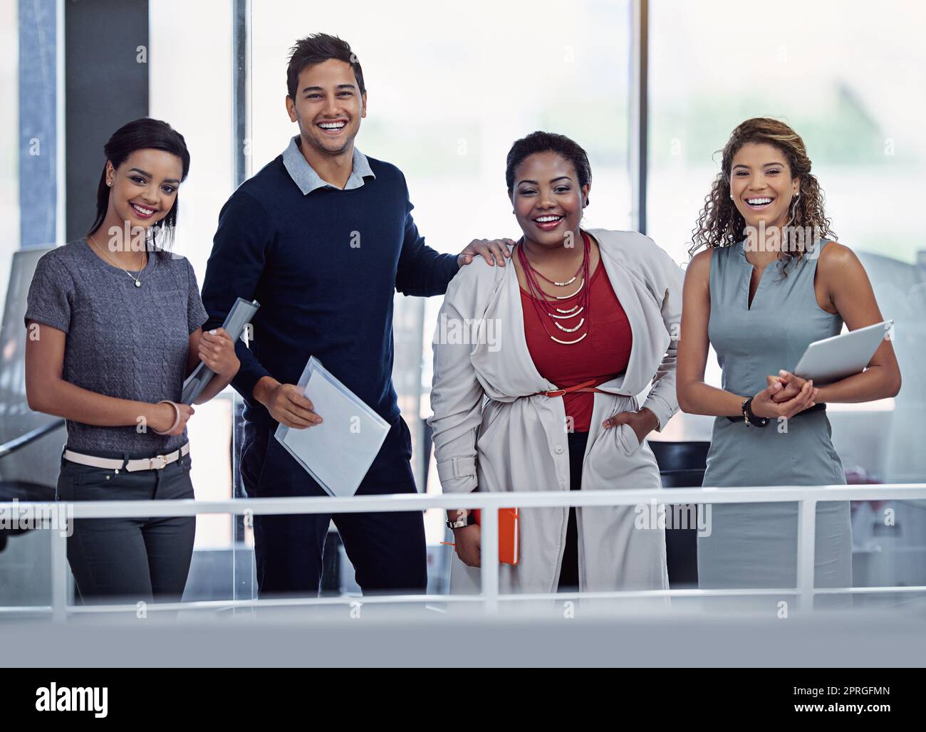 Our success depends on all of us working together. Portrait of a group of smiling colleagues working together in an office. Stock Photo