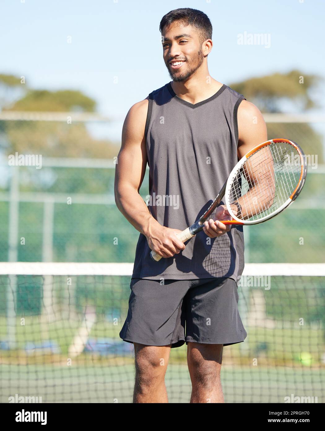 Tennis is my favourite sport. a handsome young man standing alone and