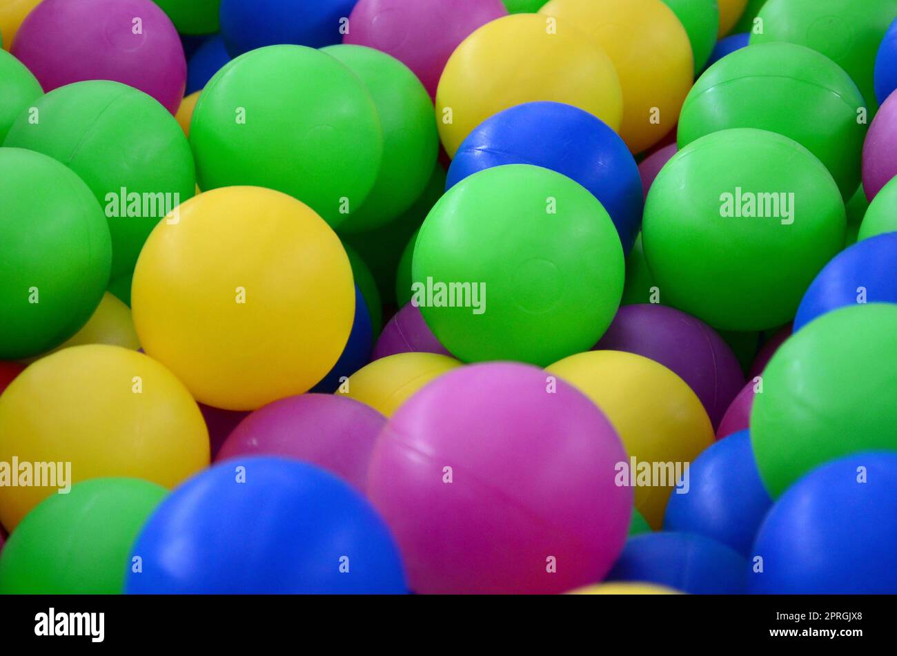 Colored plastic balls in pool of game room. Swimming pool for fun and