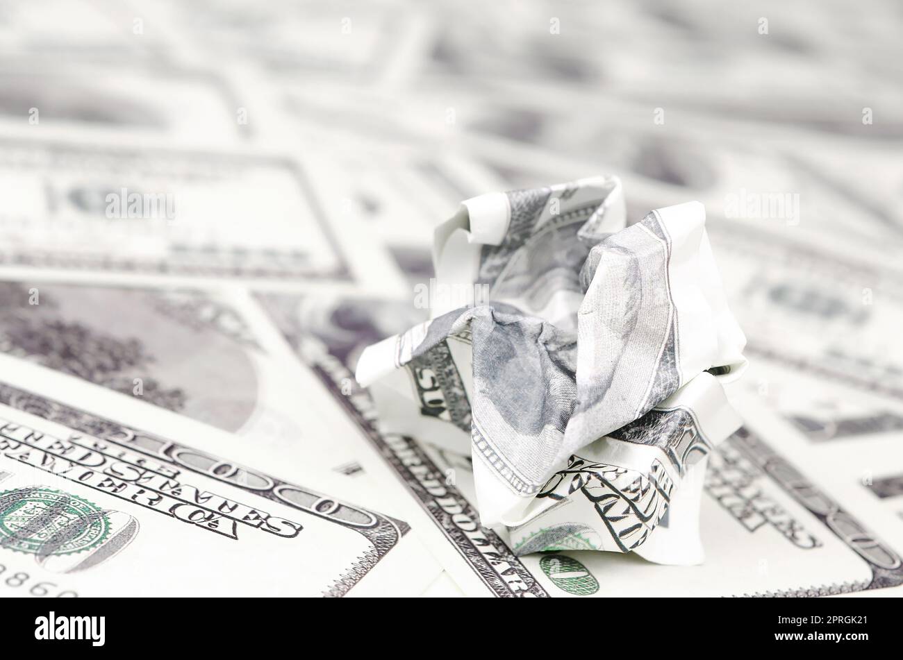 Crumpled dollar bill of the United States lies on the set of smooth money bills. Concept of unreasonable waste of money Stock Photo