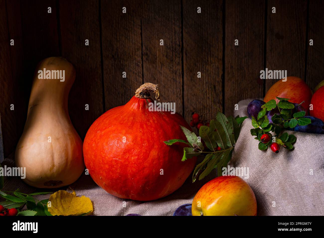 Various fruits in a wooden box with autumn leaves Stock Photo - Alamy
