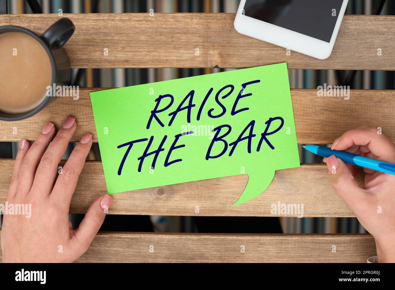 Text caption presenting Raise The Bar. Word for Set higher standards ...