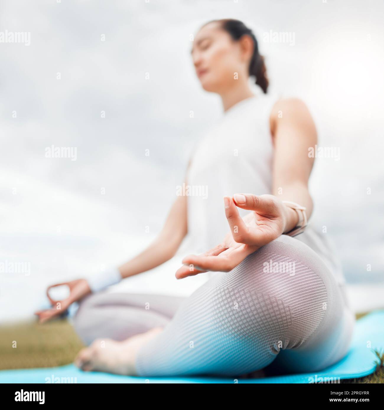 Yoga, woman and lotus meditation in nature for health, mindfulness or wellness. Training, pilates and female in Canada meditating, stretching or relax Stock Photo