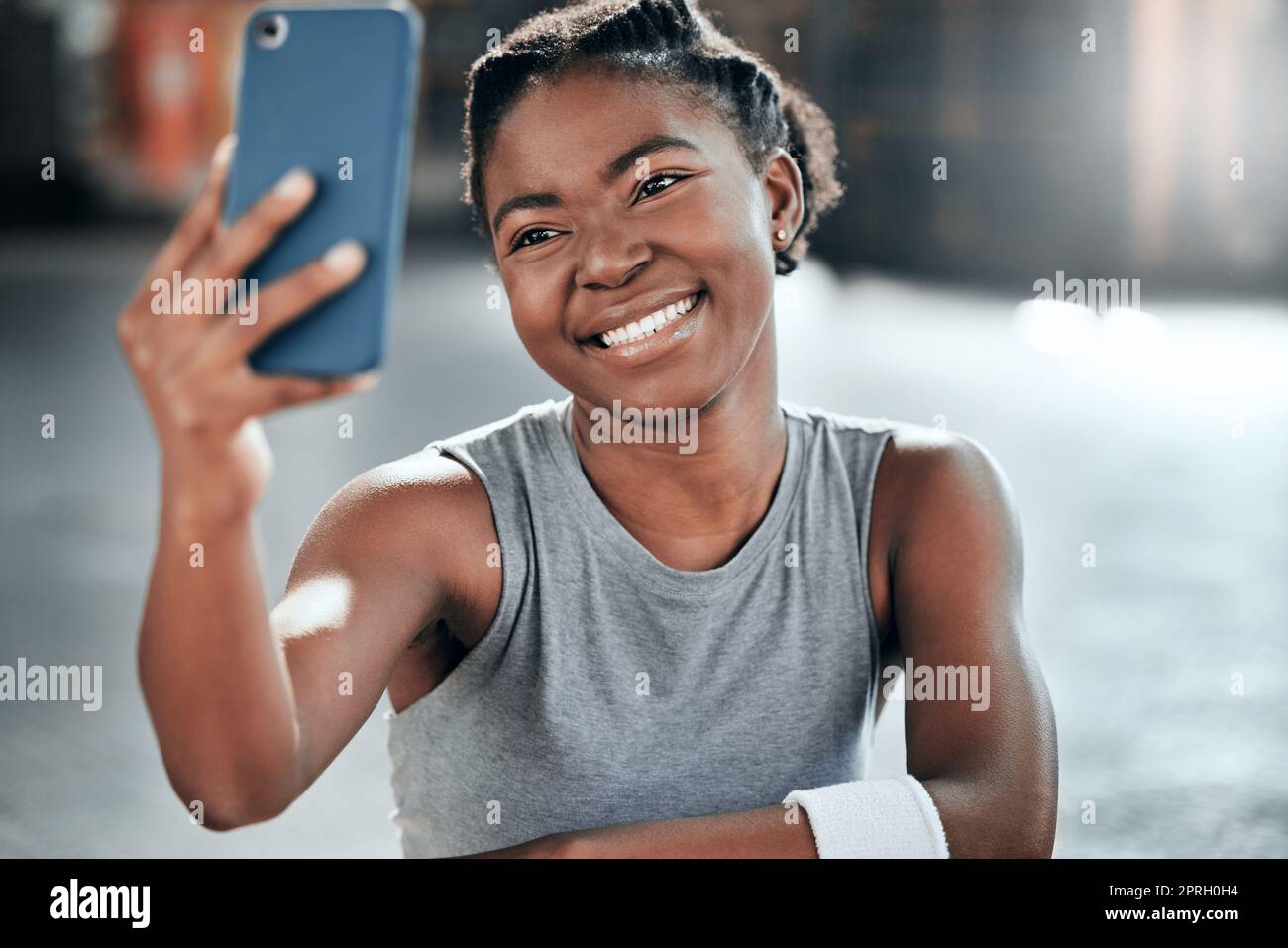 Bathe in victory. a young beautiful woman using her cellphone to take a