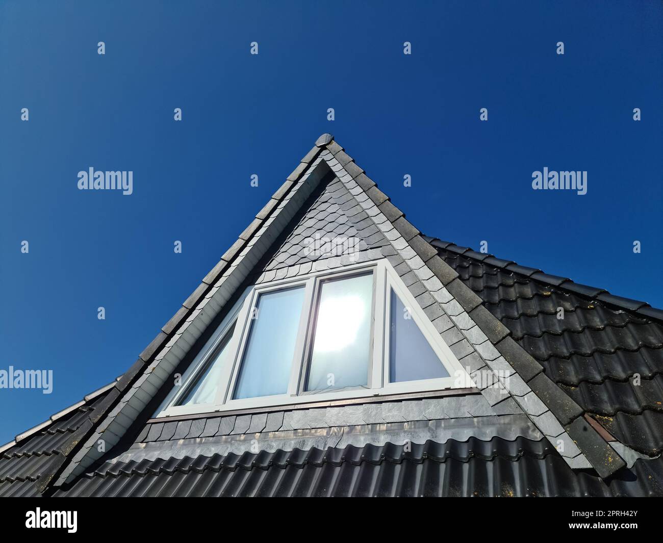 Open roof window in velux style with black roof tiles Stock Photo Alamy