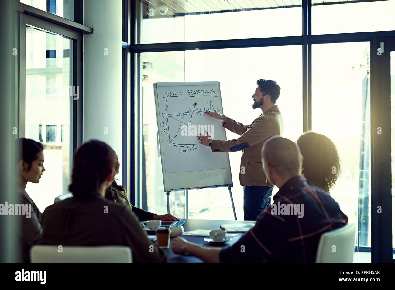 In this office, impossible is nothing. a businessman giving a presentation in the boardroom. Stock Photo