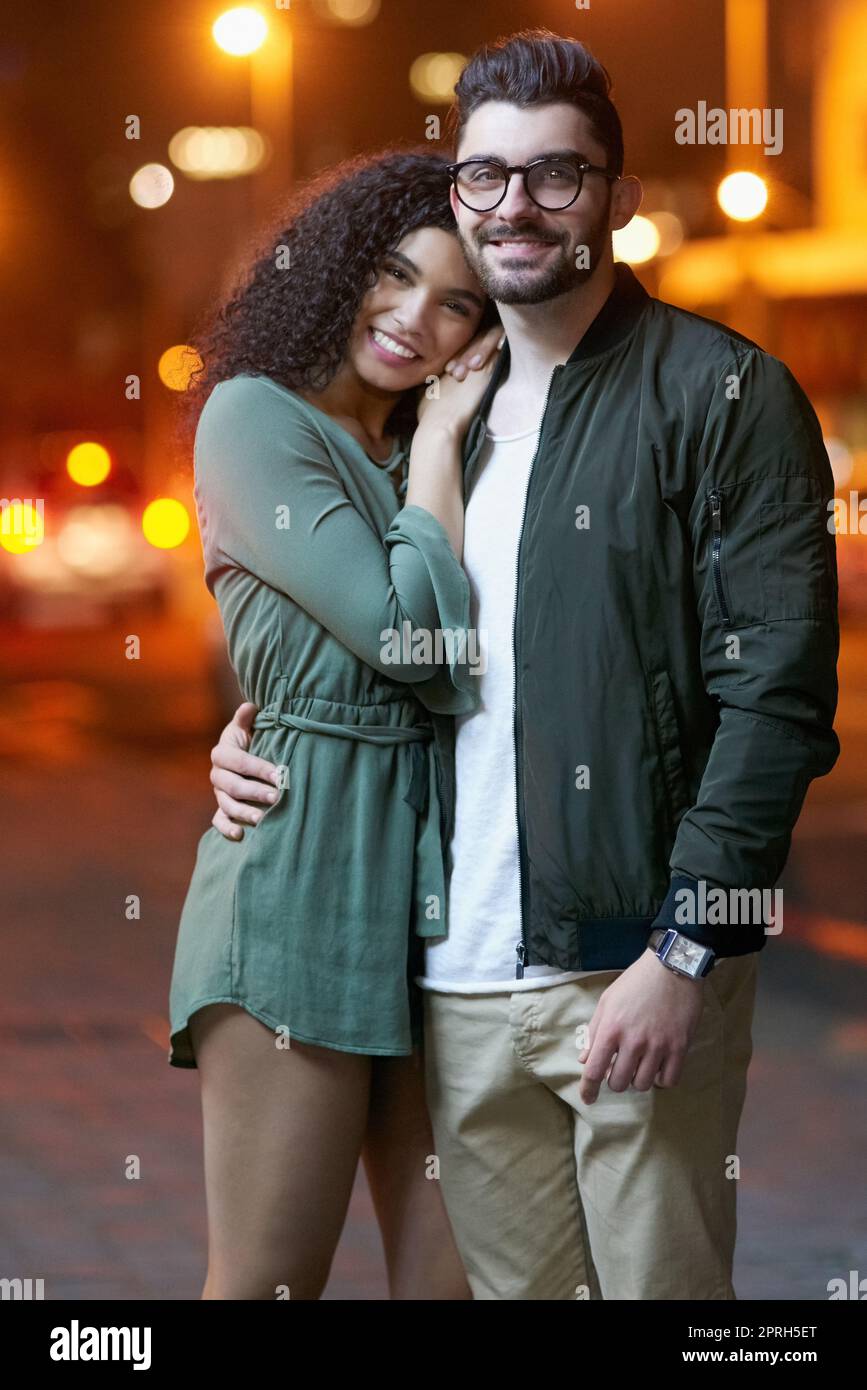 The perfect couple. Portrait of a happy young couple outdoors at night. Stock Photo