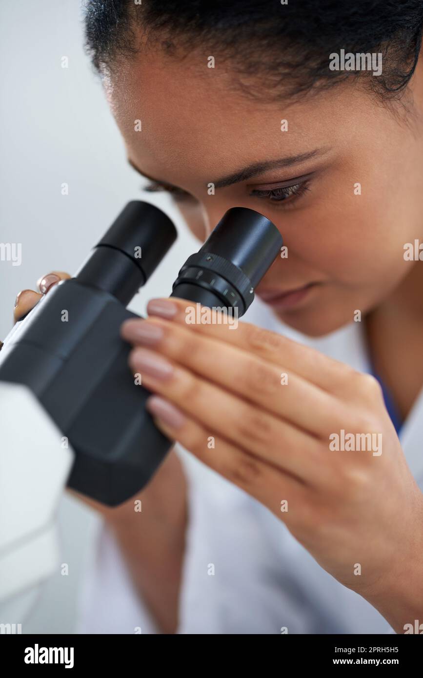 The microscope reveals all. an attractive young female scientist working in her lab. Stock Photo